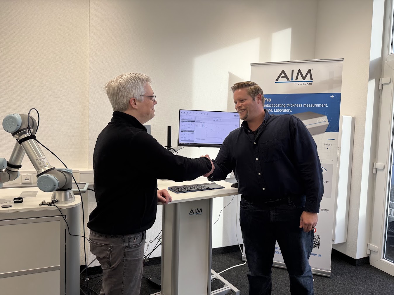 Matthew Baker of Gauge Advisor with Stefan Bottger from AIM Systems discussing coating measurement technology partnership