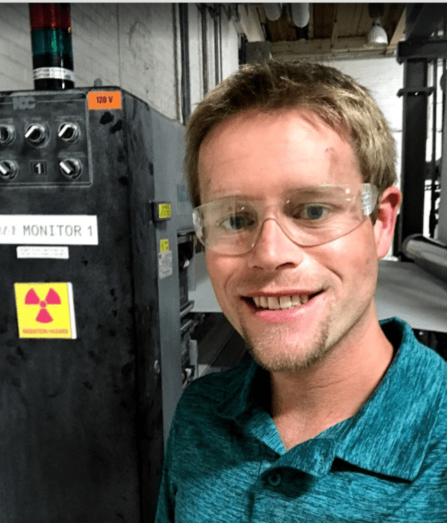Matthew Baker reviewing an industrial gauging system on a production line