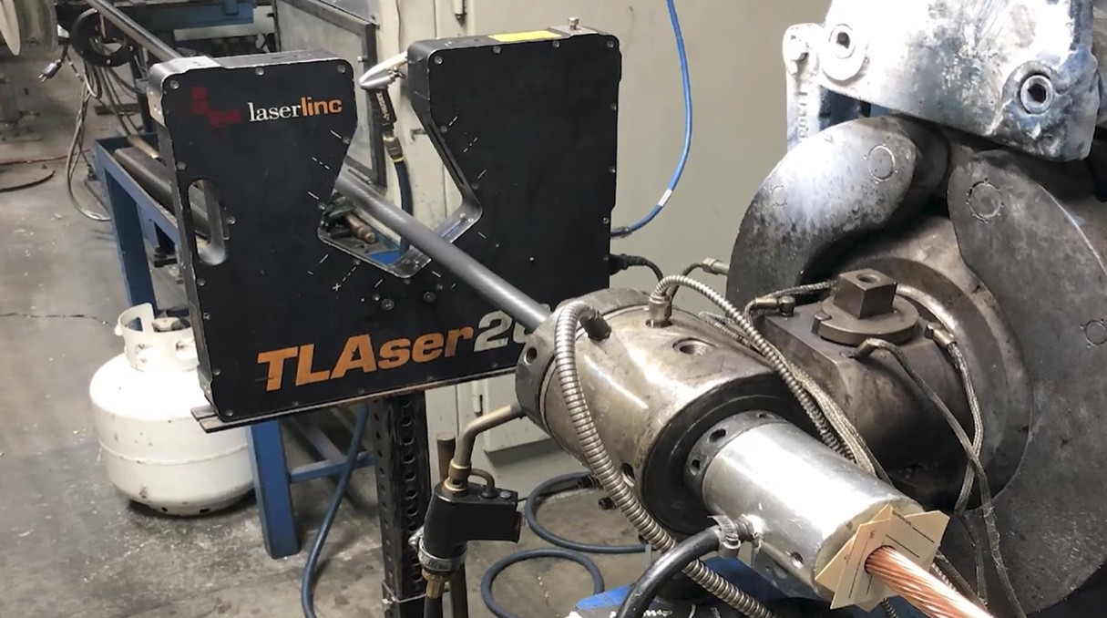 A LaserLinc dual-axis micrometer measuring outside diameter (OD) after coating has been applied.