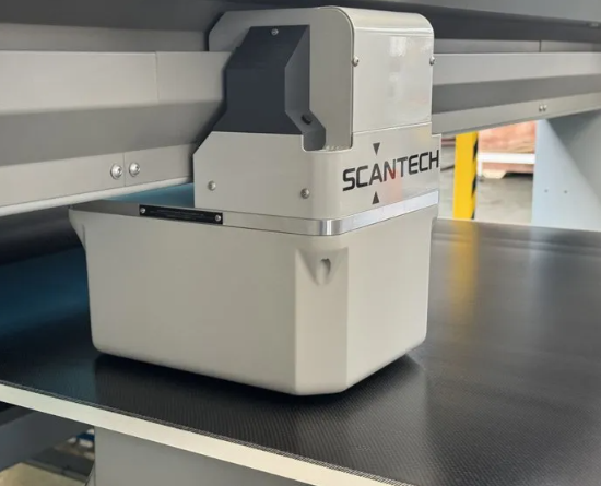 Scantech scanning measurement head inspecting prepreg composite material weight on a moving production line